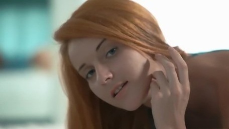 Petite redhead girl Roberta Berti strips in the bed and teases